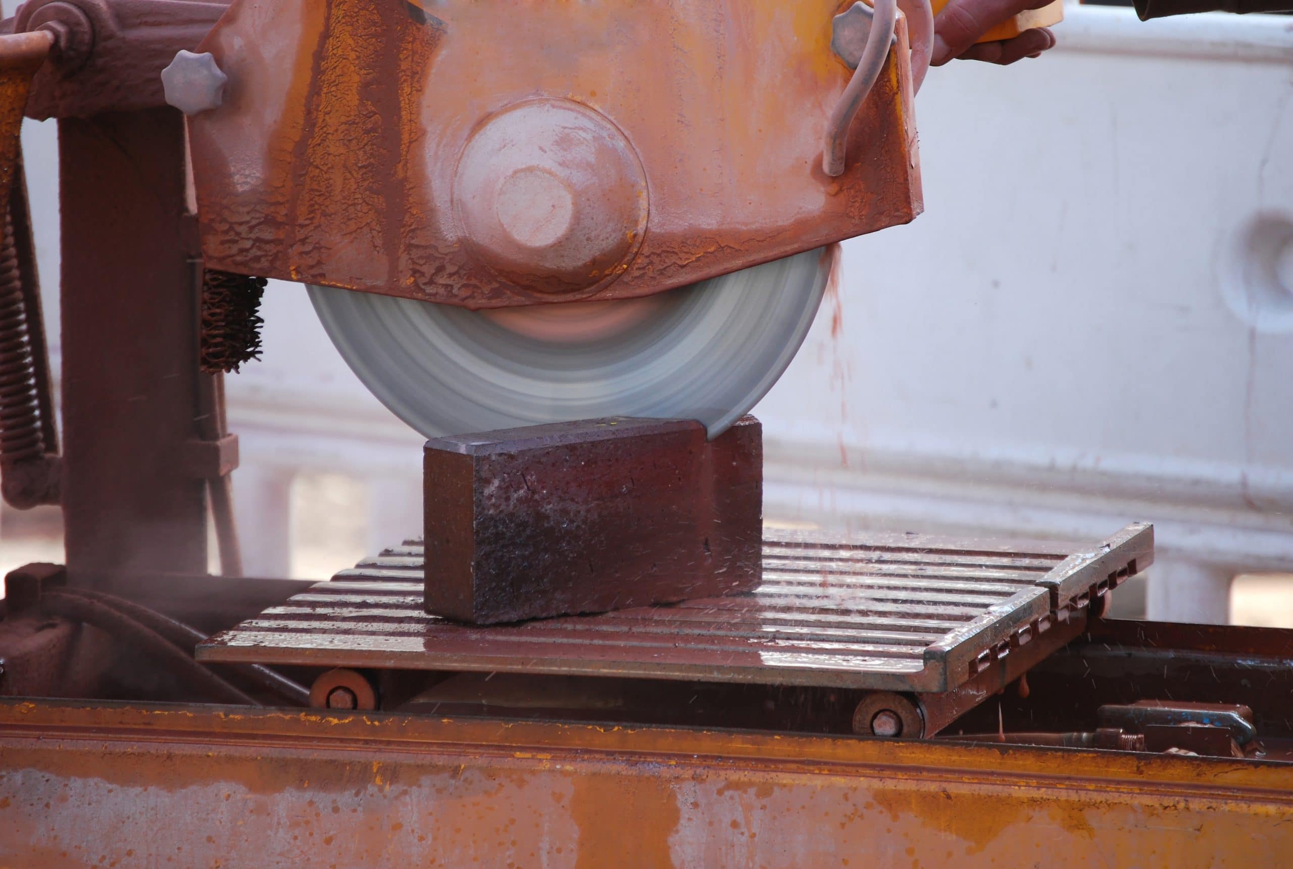 High powered masonry saw cutting a special shaped brick