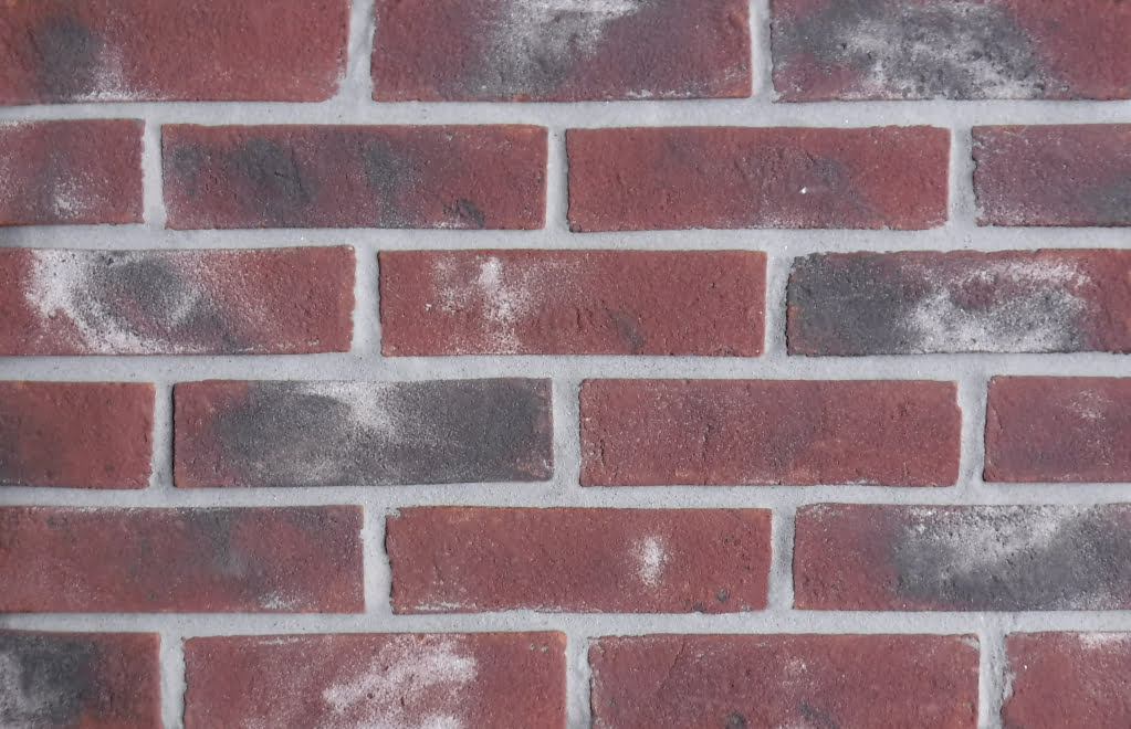 Exeter brick slips pointed with grey coloured mortar.