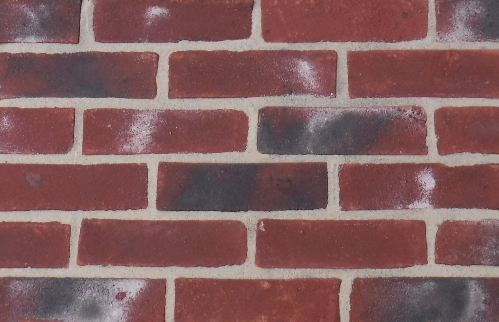 Exeter brick slips pointed with light buff coloured mortar.