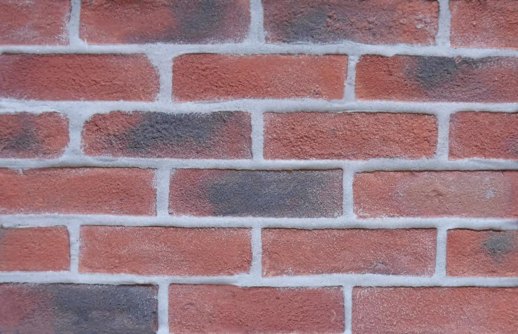 Kingston Antique brick slips pointed with grey coloured mortar.
